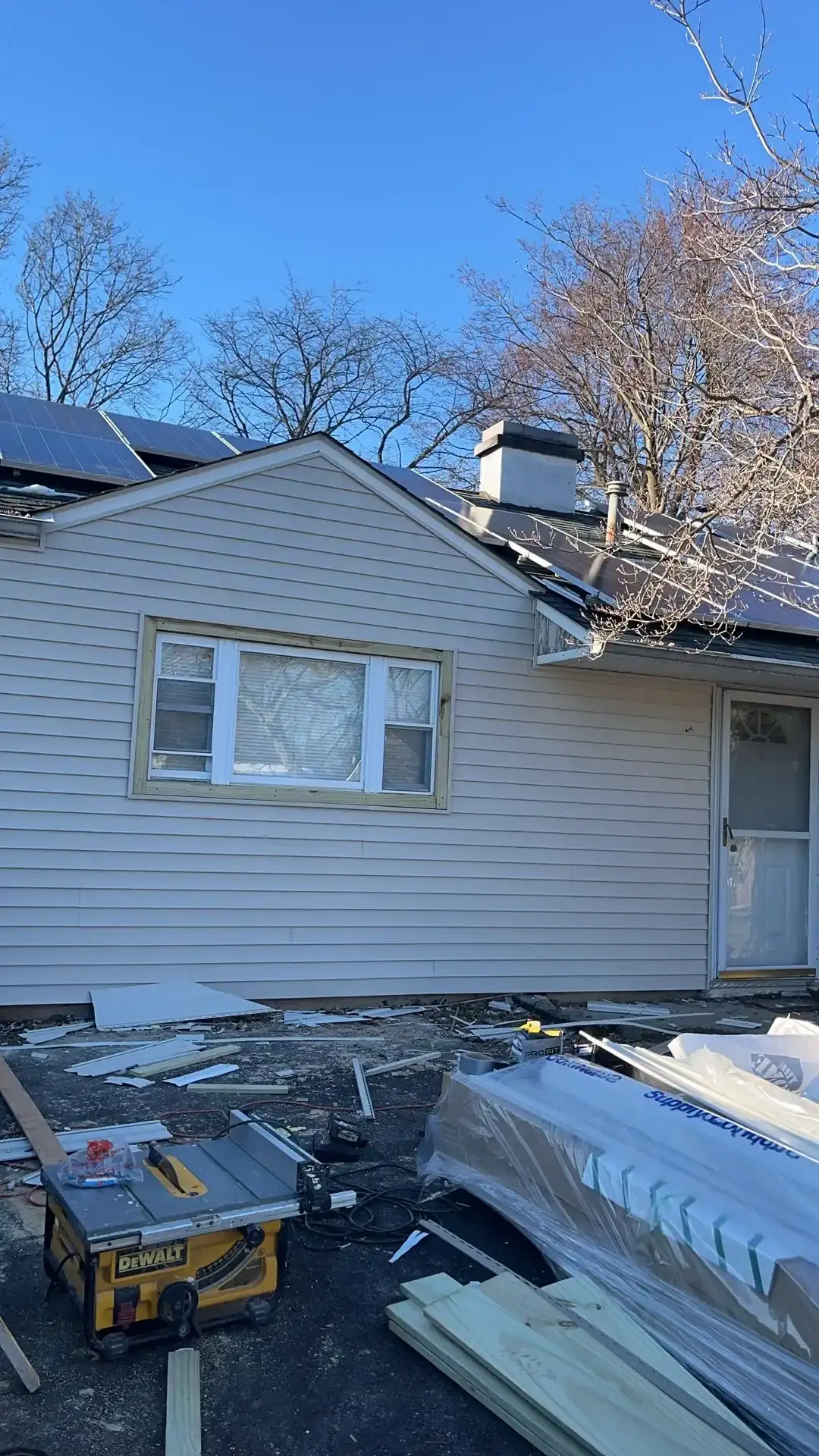 Rear addition finished with vinyl siding and new windows
