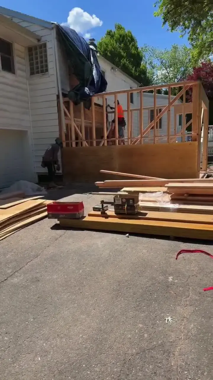 Addition wall framing being raised, job-site video