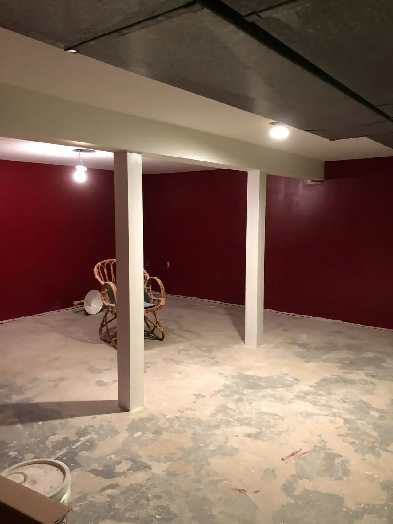 Unfinished basement with concrete floor before remodeling