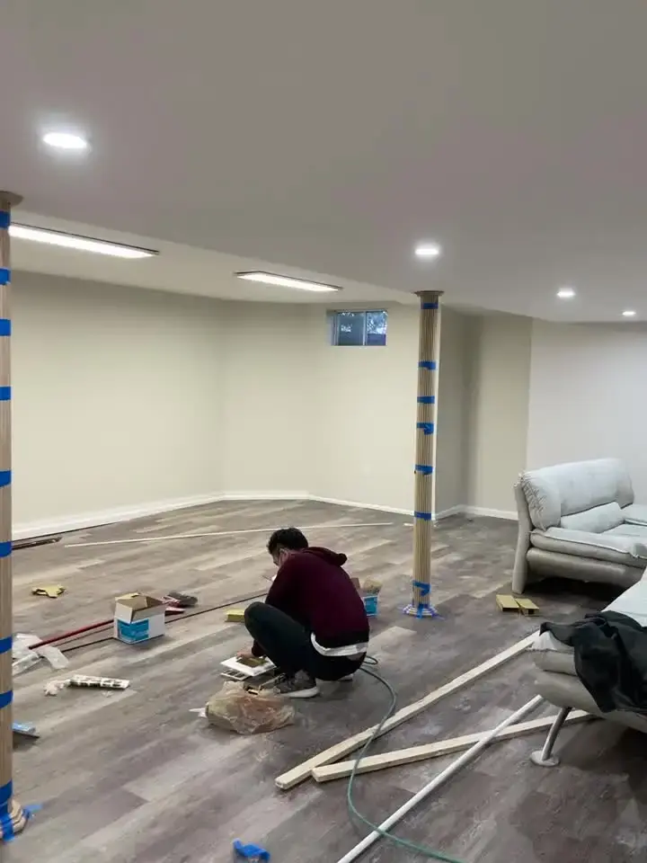 Basement with new vinyl plank flooring and recessed lights, final stage