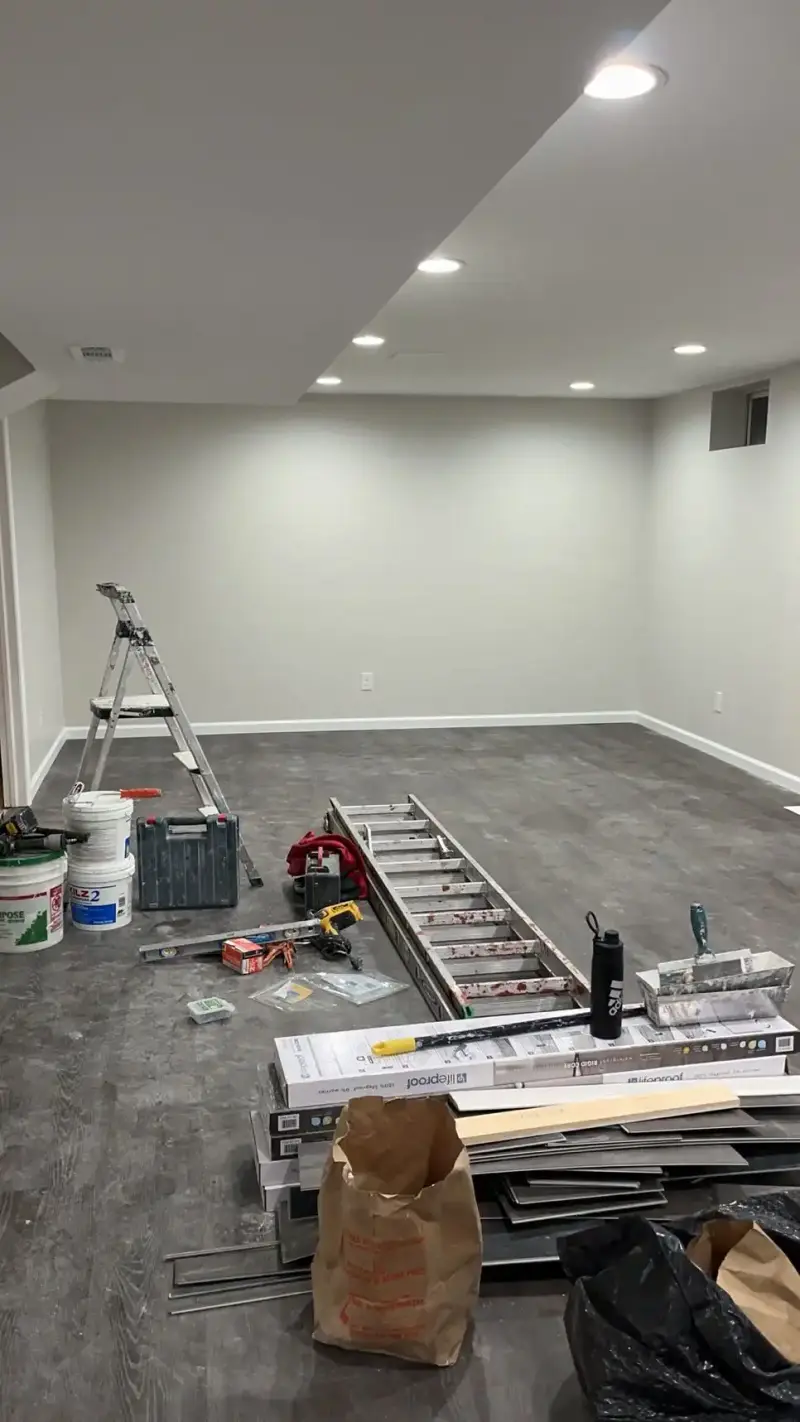 Finished basement with drywall soffits, recessed lights and new doors