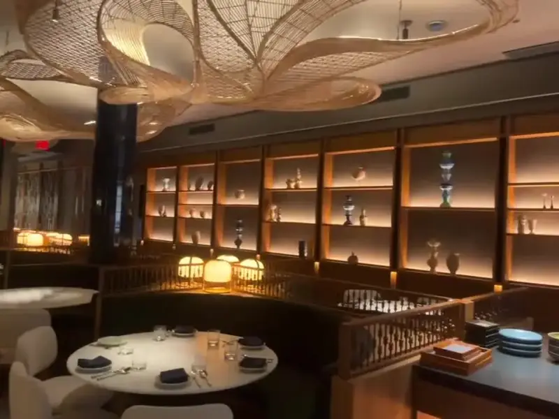 Finished restaurant dining room with backlit shelving